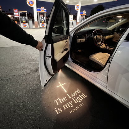 Psalm 27:1 The Lord is my light glowing on the ground under a car door
