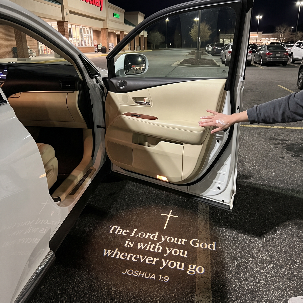 Joshua 1:9 glowing on the ground under a car door