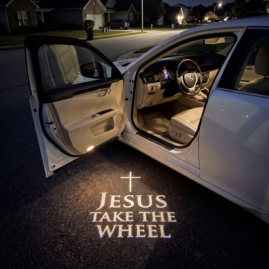 HaloDoor projecting Jesus Take the Wheel on the ground beside an open car door at night