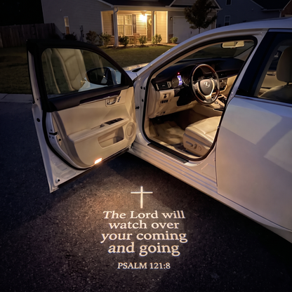 Psalm 121:8 glowing on the ground under a car door